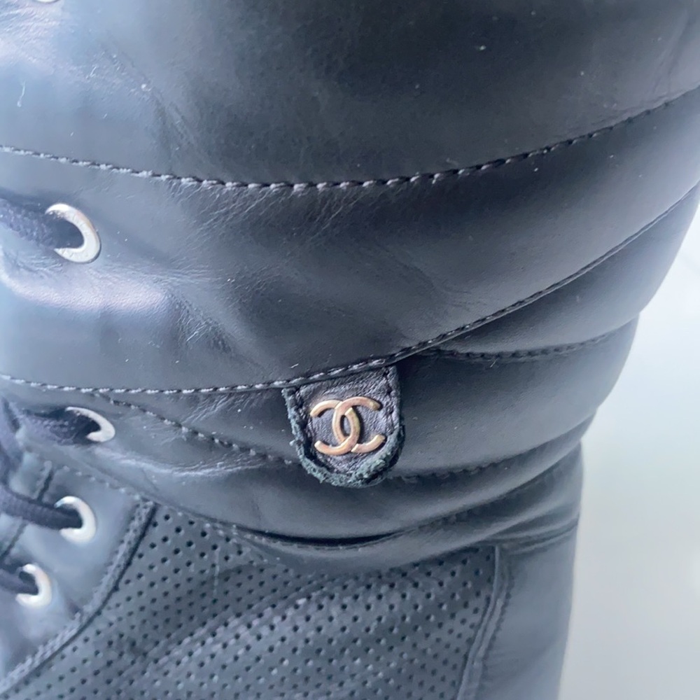 Black perforated leather Chanel logo boots